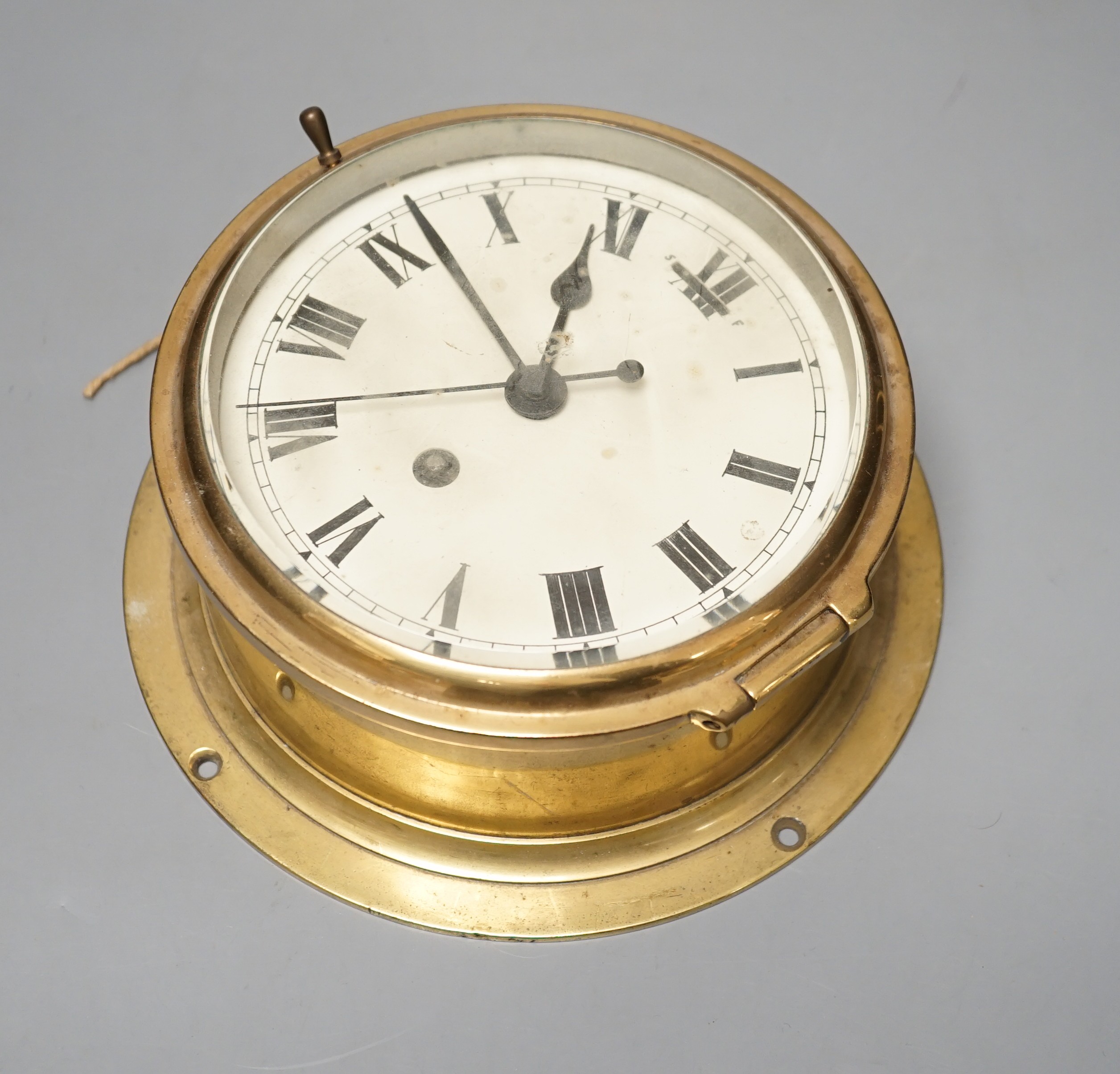 An early 20th century brass ships bulkhead timepiece with key